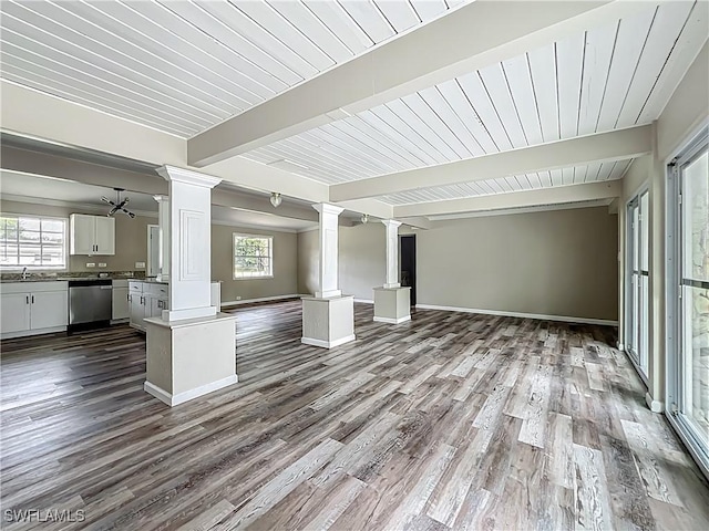 93 E Mariana Ave, North Fort Myers, FL 33917 - unfurnished living room with decorative columns, healthy amount of natural light, dark wood-type flooring, and a wooden ceiling with exposed beams