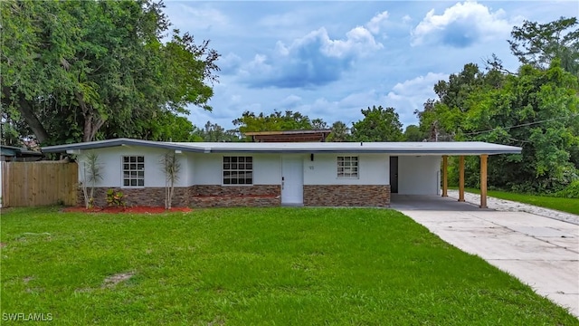 93 E Mariana Ave, North Fort Myers, FL 33917 - view of front of home with stone siding, stucco siding, a carport, and driveway