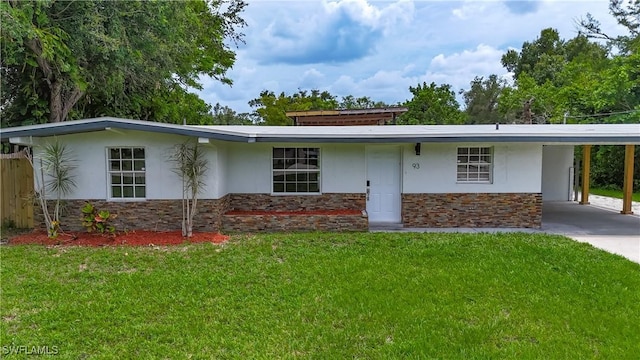 93 E Mariana Ave, North Fort Myers, FL 33917 - view of front of property with stone siding, stucco siding, a front lawn, and an attached carport