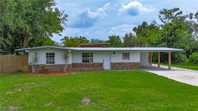 93 E Mariana Ave, North Fort Myers, FL 33917 - view of front of home with stone siding, stucco siding, a carport, and driveway