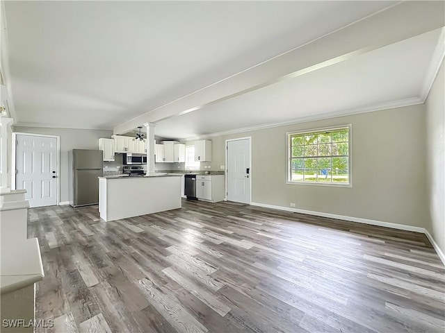 93 E Mariana Ave, North Fort Myers, FL 33917 - kitchen with stainless steel appliances, open floor plan, dark wood-style floors, white cabinetry, and crown molding
