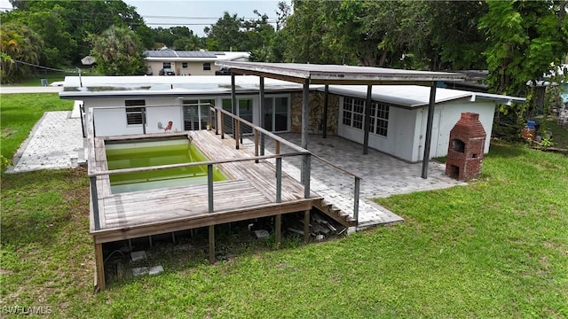 93 E Mariana Ave, North Fort Myers, FL 33917 - rear view of house featuring a lawn, a patio, and a wooden deck
