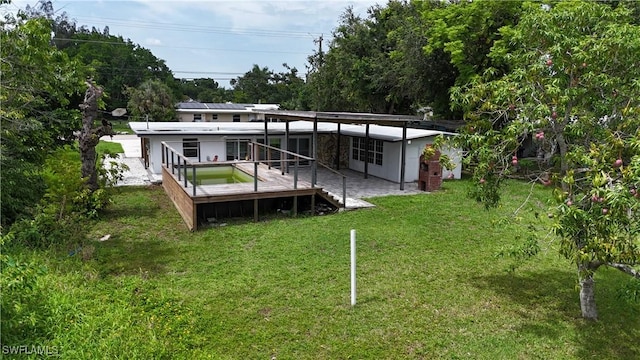 93 E Mariana Ave, North Fort Myers, FL 33917 - rear view of property featuring a yard and a deck