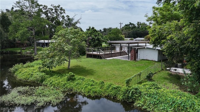 93 E Mariana Ave, North Fort Myers, FL 33917 - view of green lawn featuring a deck with water view