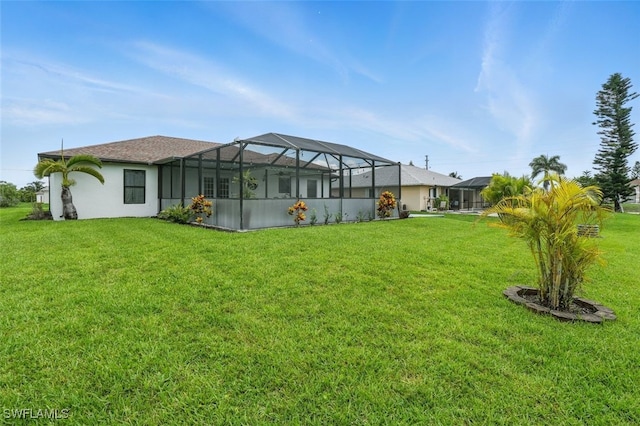 4903 Bygone St, Lehigh Acres, FL 33971 - rear view of property with a lawn and a lanai