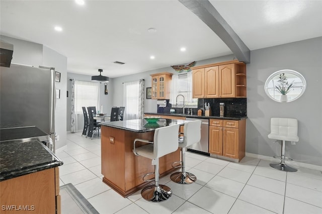 4903 Bygone St, Lehigh Acres, FL 33971 - kitchen featuring appliances with stainless steel finishes, a center island, healthy amount of natural light, recessed lighting, and a kitchen breakfast bar
