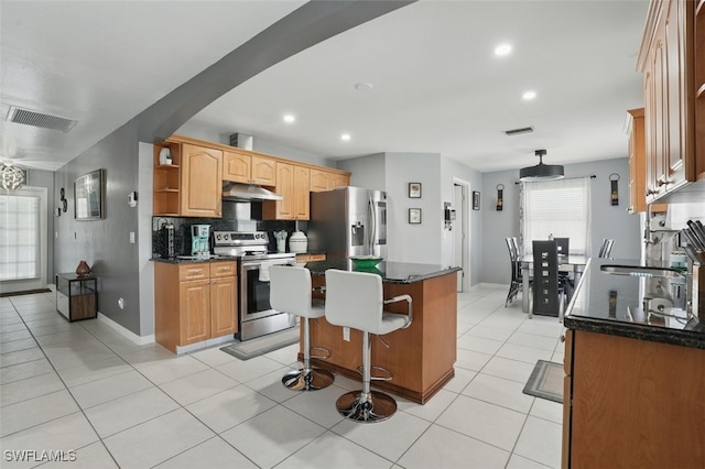 4903 Bygone St, Lehigh Acres, FL 33971 - kitchen featuring appliances with stainless steel finishes, under cabinet range hood, a center island, open shelves, and decorative backsplash