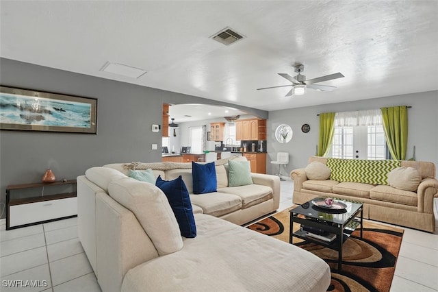 4903 Bygone St, Lehigh Acres, FL 33971 - living area featuring arched walkways, light tile patterned floors, ceiling fan, and plenty of natural light