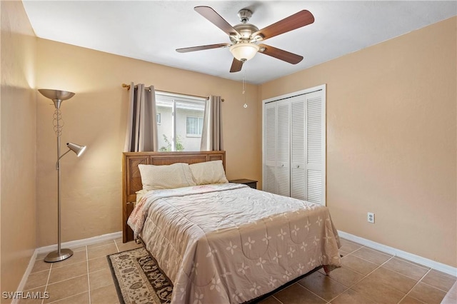 2012 SW 8th Ct, Cape Coral, FL 33991 - bedroom featuring light tile patterned floors, a closet, baseboards, and a ceiling fan