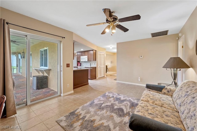 2012 SW 8th Ct, Cape Coral, FL 33991 - living area with light tile patterned flooring, ceiling fan, and baseboards
