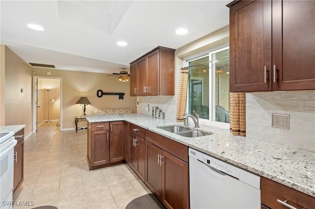 2012 SW 8th Ct, Cape Coral, FL 33991 - kitchen featuring white dishwasher, a sink, backsplash, light tile patterned floors, and a peninsula