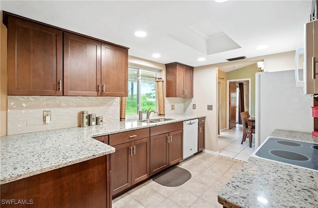 2012 SW 8th Ct, Cape Coral, FL 33991 - kitchen featuring dishwasher, a sink, decorative backsplash, light tile patterned floors, and light stone countertops