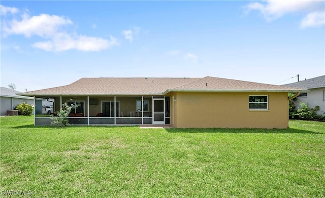 2012 SW 8th Ct, Cape Coral, FL 33991 - back of house with a sunroom, a yard, stucco siding, and central AC