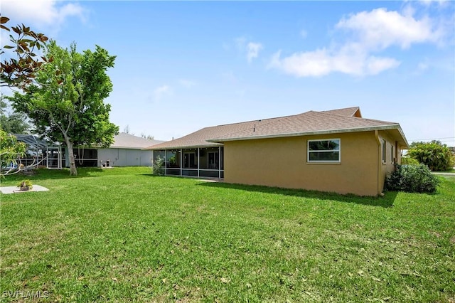 2012 SW 8th Ct, Cape Coral, FL 33991 - back of house with a lawn, stucco siding, and a sunroom