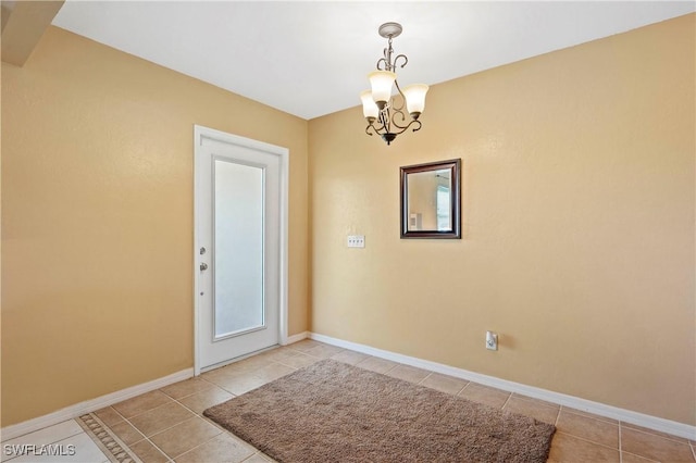 2012 SW 8th Ct, Cape Coral, FL 33991 - spare room with a chandelier, light tile patterned floors, and baseboards