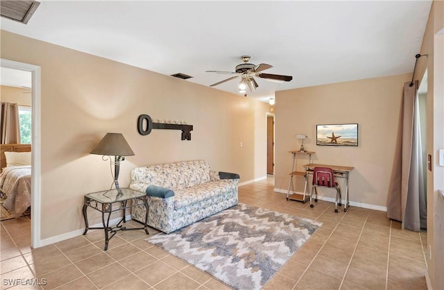 2012 SW 8th Ct, Cape Coral, FL 33991 - living room featuring tile patterned floors, a ceiling fan, and baseboards