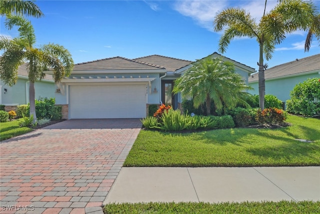 14594 Tropical Dr, Naples, FL 34114 - view of front of house with a garage, driveway, a front yard, and stucco siding