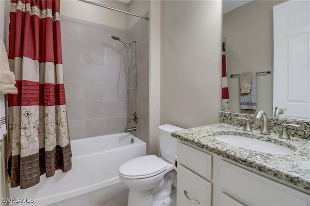14594 Tropical Dr, Naples, FL 34114 - bathroom featuring toilet, shower / bath combo with shower curtain, vanity, and tile patterned flooring