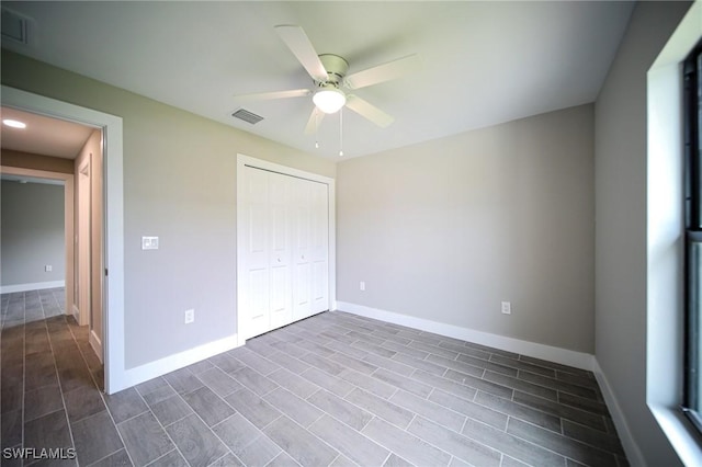 374 Pennfield St, Lehigh Acres, FL 33974 - unfurnished bedroom featuring a closet, baseboards, and ceiling fan