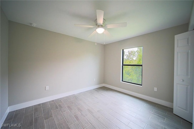374 Pennfield St, Lehigh Acres, FL 33974 - spare room with baseboards, ceiling fan, wood finished floors, and a smoke detector