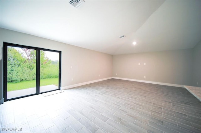 374 Pennfield St, Lehigh Acres, FL 33974 - empty room with baseboards, lofted ceiling, and recessed lighting