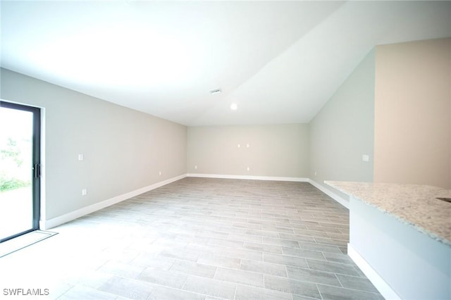 374 Pennfield St, Lehigh Acres, FL 33974 - additional living space with vaulted ceiling and baseboards
