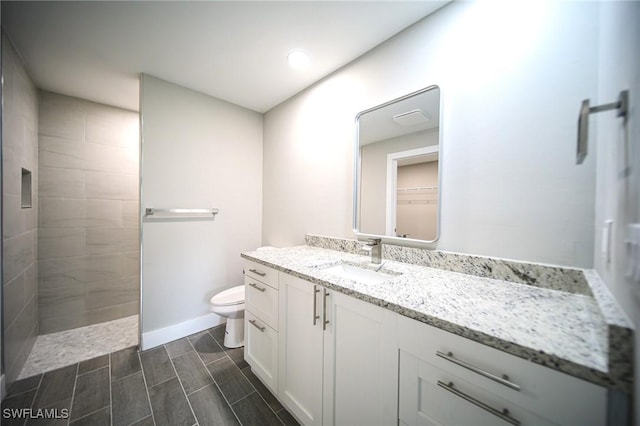 374 Pennfield St, Lehigh Acres, FL 33974 - full bath featuring toilet, vanity, walk in shower, wood tiled floors, and baseboards