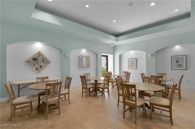 740 N Collier Blvd Unit 206, Marco Island, FL 34145 - dining area with arched walkways, light tile patterned floors, baseboards, a drop ceiling, and recessed lighting