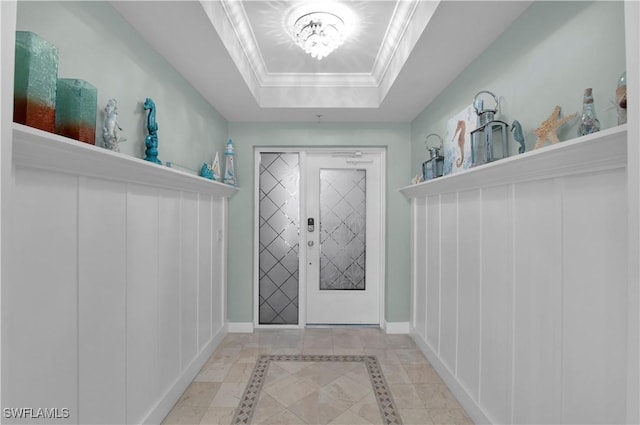 740 N Collier Blvd Unit 206, Marco Island, FL 34145 - foyer with inlaid floor details, a chandelier, a raised ceiling, and baseboards