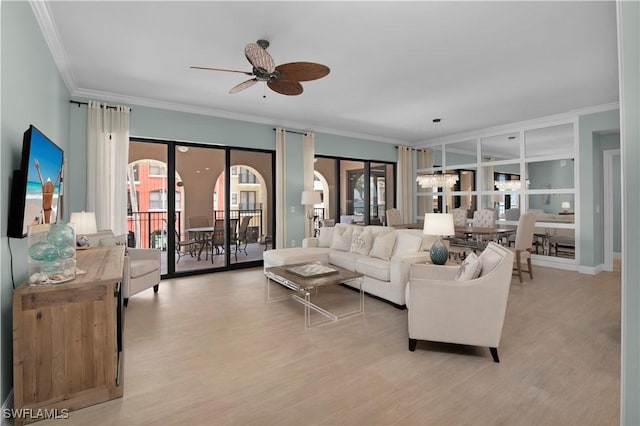 740 N Collier Blvd Unit 206, Marco Island, FL 34145 - living room featuring a ceiling fan, crown molding, light wood-type flooring, a chandelier, and healthy amount of natural light