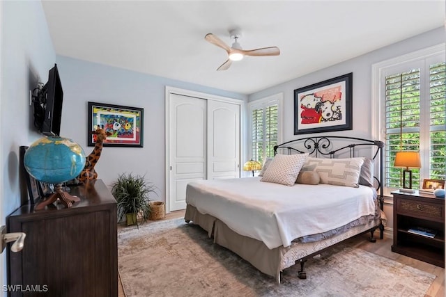12147 Colliers Reserve Dr, Naples, FL 34110 - bedroom featuring a closet, wood finished floors, and ceiling fan
