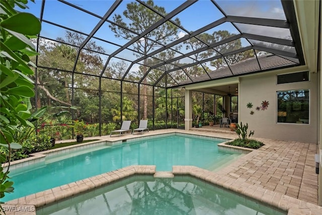 12147 Colliers Reserve Dr, Naples, FL 34110 - view of swimming pool with a pool with connected hot tub, a patio area, and glass enclosure