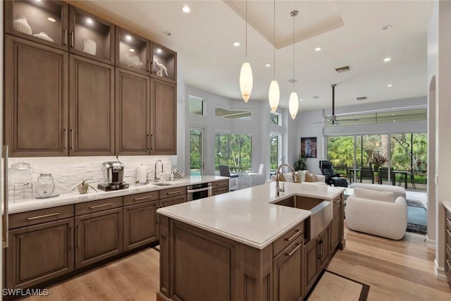 12147 Colliers Reserve Dr, Naples, FL 34110 - kitchen featuring a sink, open floor plan, light wood-type flooring, light countertops, and recessed lighting