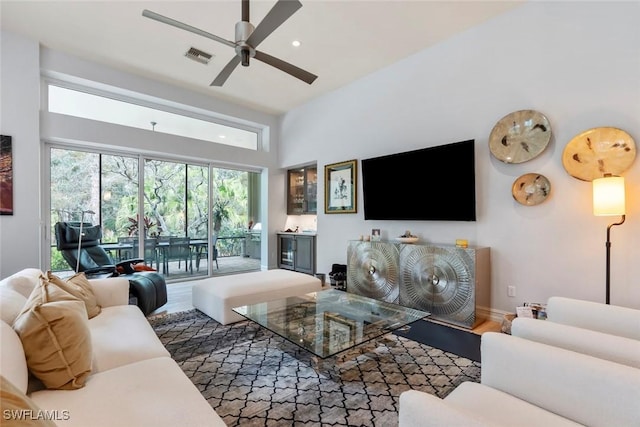12147 Colliers Reserve Dr, Naples, FL 34110 - living room with ceiling fan, wood finished floors, recessed lighting, and a high ceiling