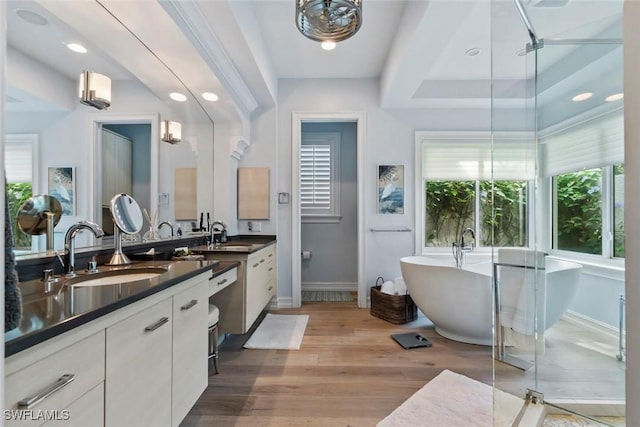 12147 Colliers Reserve Dr, Naples, FL 34110 - full bath with vanity, baseboards, a freestanding bath, wood finished floors, and recessed lighting