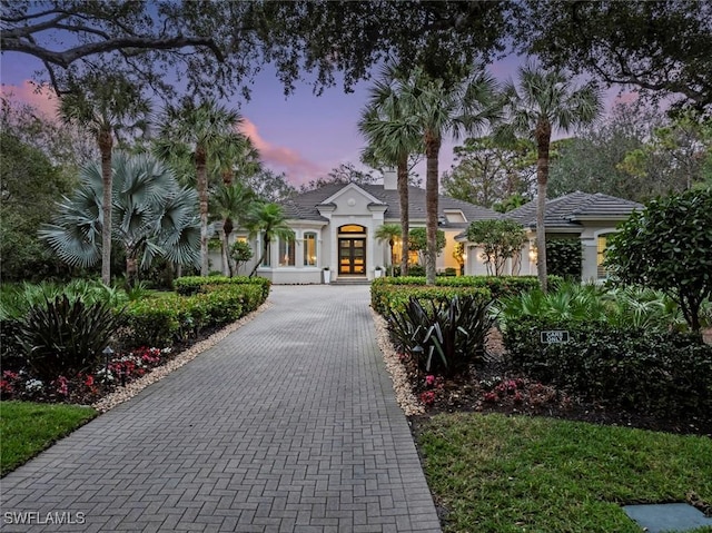 12147 Colliers Reserve Dr, Naples, FL 34110 - view of front of home featuring french doors and stucco siding