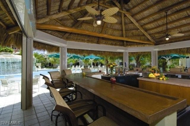 3881 Kens Way Unit 4301, Bonita Springs, FL 34134 - view of patio with a gazebo, ceiling fan, exterior bar, and an outdoor pool