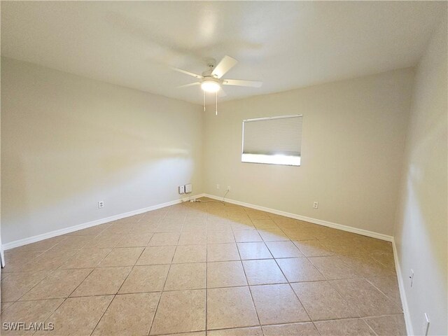 1221 SW 10th Ter, Cape Coral, FL 33991 - empty room featuring ceiling fan, light tile patterned flooring, and baseboards