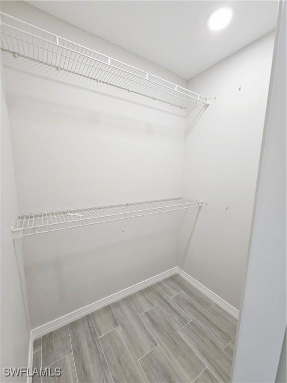 1221 SW 10th Ter, Cape Coral, FL 33991 - walk in closet featuring wood finish floors