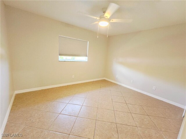 1221 SW 10th Ter, Cape Coral, FL 33991 - empty room with light tile patterned flooring, a ceiling fan, and baseboards