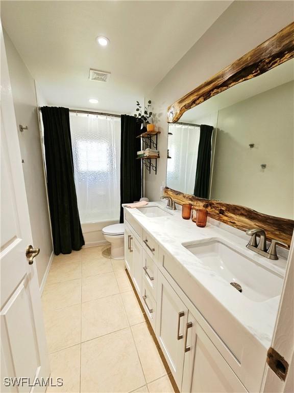 1221 SW 10th Ter, Cape Coral, FL 33991 - bathroom with tile patterned flooring, shower / tub combo, double vanity, toilet, and recessed lighting