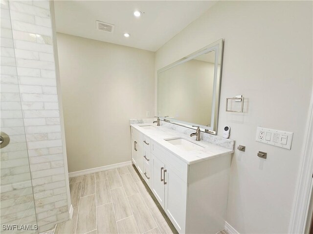 1221 SW 10th Ter, Cape Coral, FL 33991 - full bath with double vanity, baseboards, recessed lighting, and a tile shower