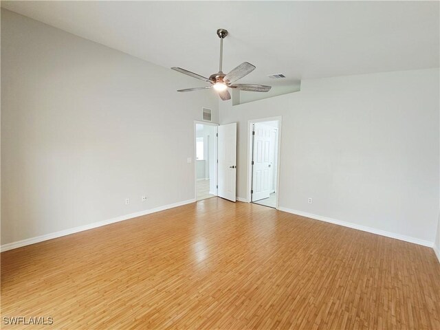 1221 SW 10th Ter, Cape Coral, FL 33991 - spare room featuring light wood-style flooring, baseboards, a ceiling fan, and lofted ceiling