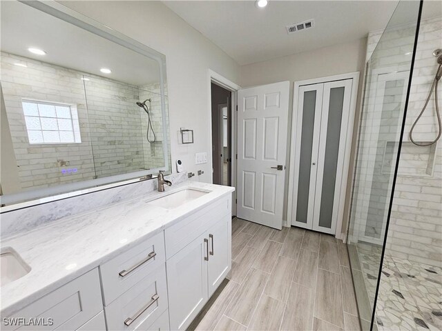 1221 SW 10th Ter, Cape Coral, FL 33991 - bathroom with double vanity, tiled shower, and recessed lighting