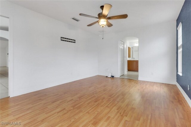 1622 SE 20th St, Cape Coral, FL 33990 - unfurnished room featuring arched walkways, ceiling fan, and light wood-type flooring