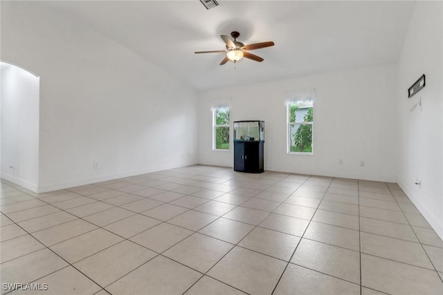 1622 SE 20th St, Cape Coral, FL 33990 - spare room featuring ceiling fan, light tile patterned flooring, arched walkways, vaulted ceiling, and baseboards