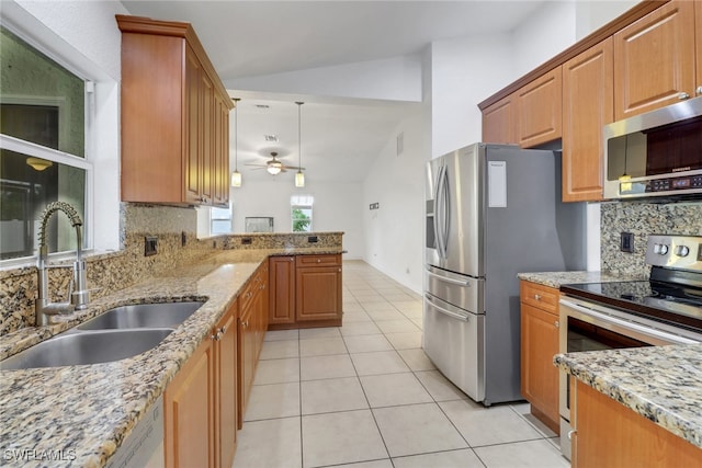 1622 SE 20th St, Cape Coral, FL 33990 - kitchen with stainless steel appliances, a sink, lofted ceiling, light tile patterned flooring, and decorative backsplash