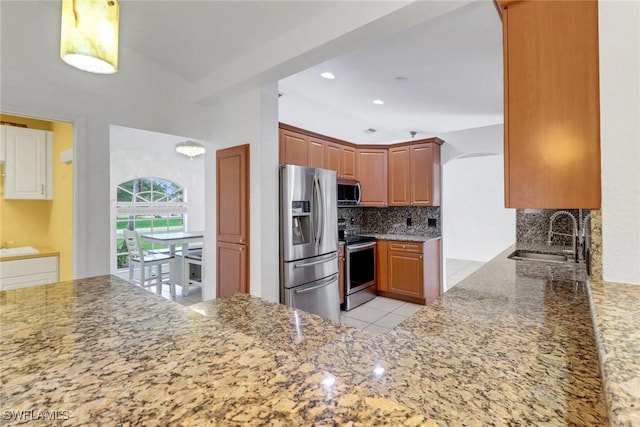 1622 SE 20th St, Cape Coral, FL 33990 - kitchen with appliances with stainless steel finishes, a sink, tasteful backsplash, light stone counters, and light tile patterned floors