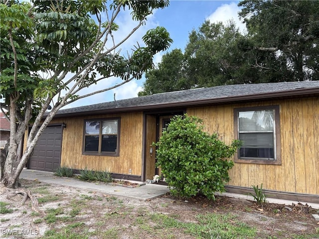 2325 55th Ter SW, Naples, FL 34116 - view of front of property with roof with shingles and a garage