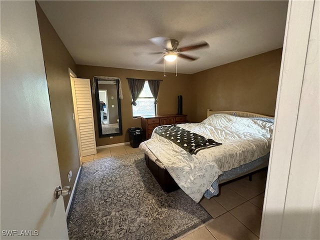 2325 55th Ter SW, Naples, FL 34116 - bedroom with light tile patterned floors and a ceiling fan